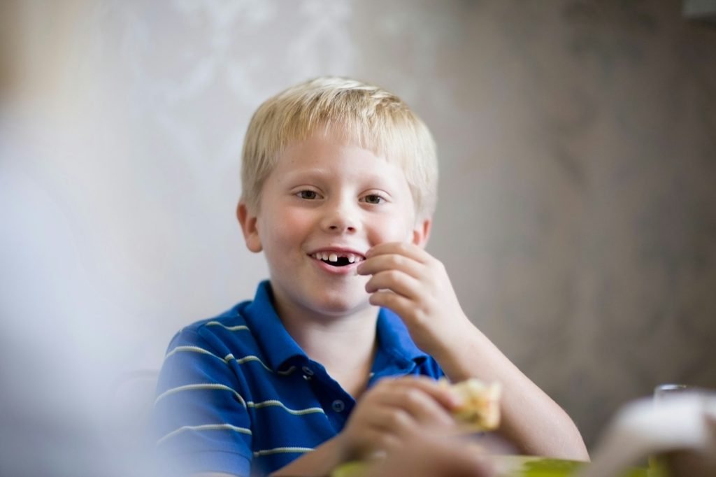 Boy eating at dinner table